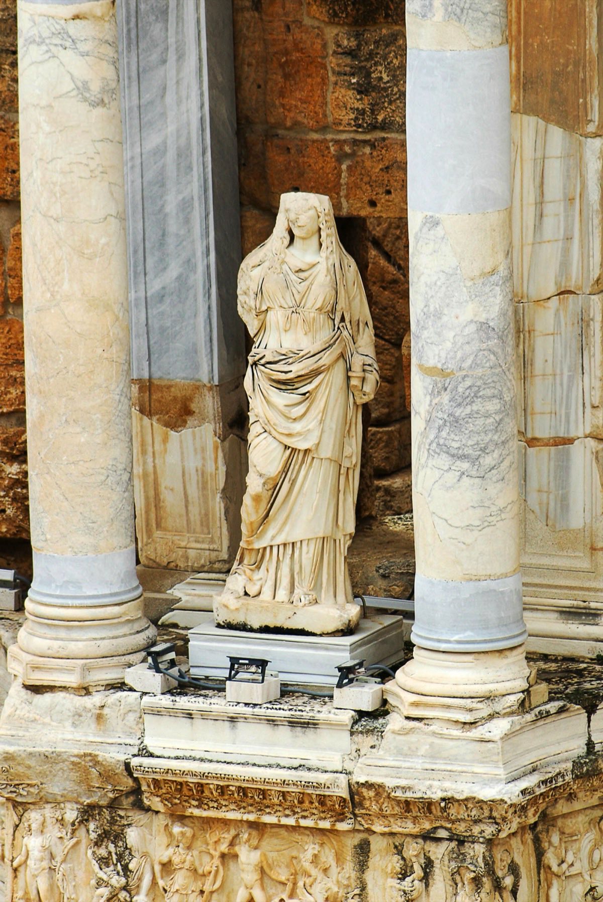 Ancient Marble Statue Surrounded By Roman Columns
