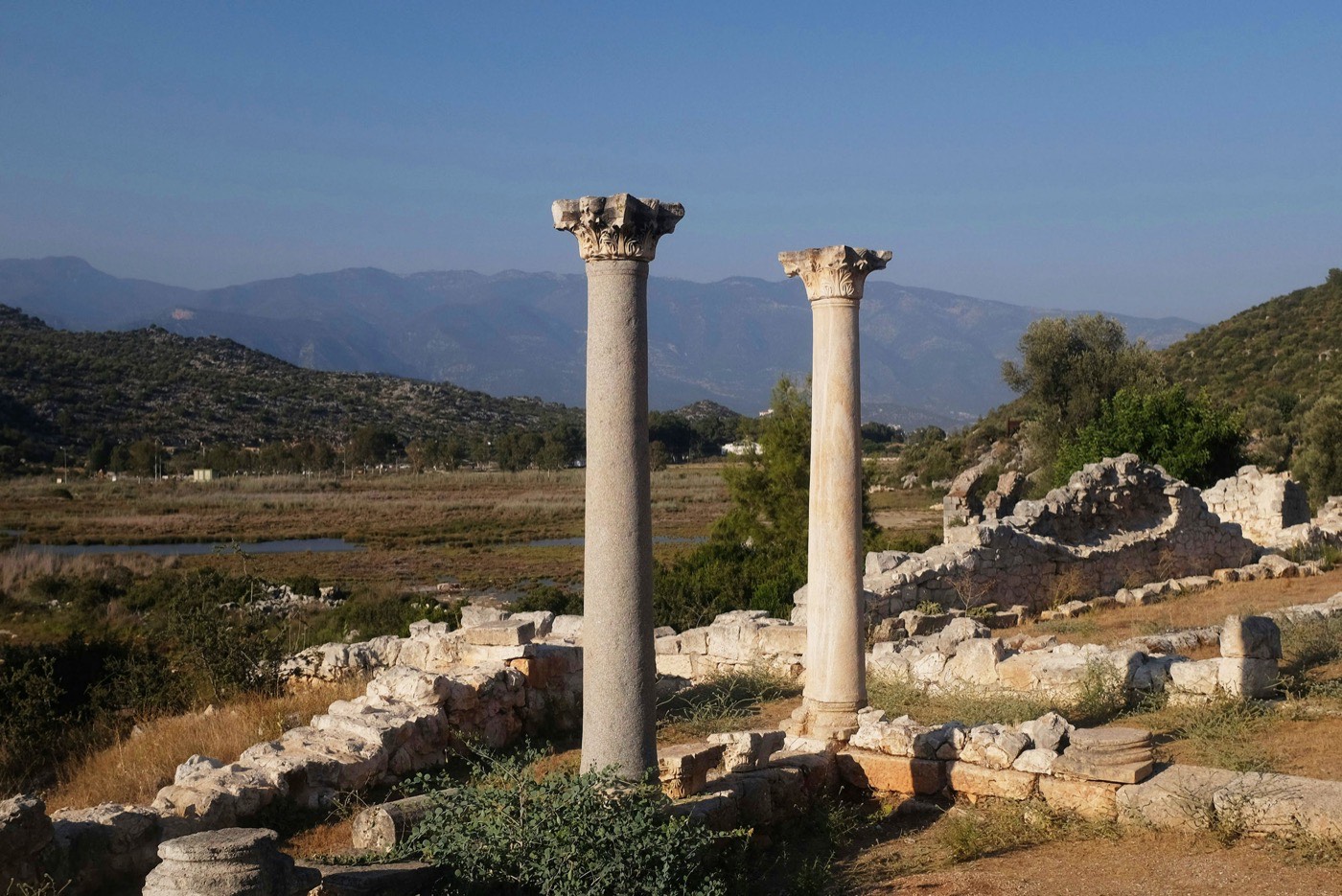 City Ruins With The Hill Of Acrocorinth In The Background