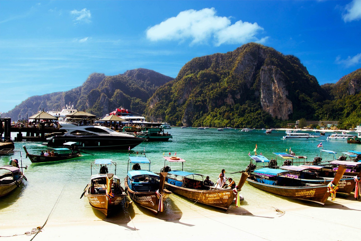 Yellow Wooden Boat Dock On White Sand Beach
