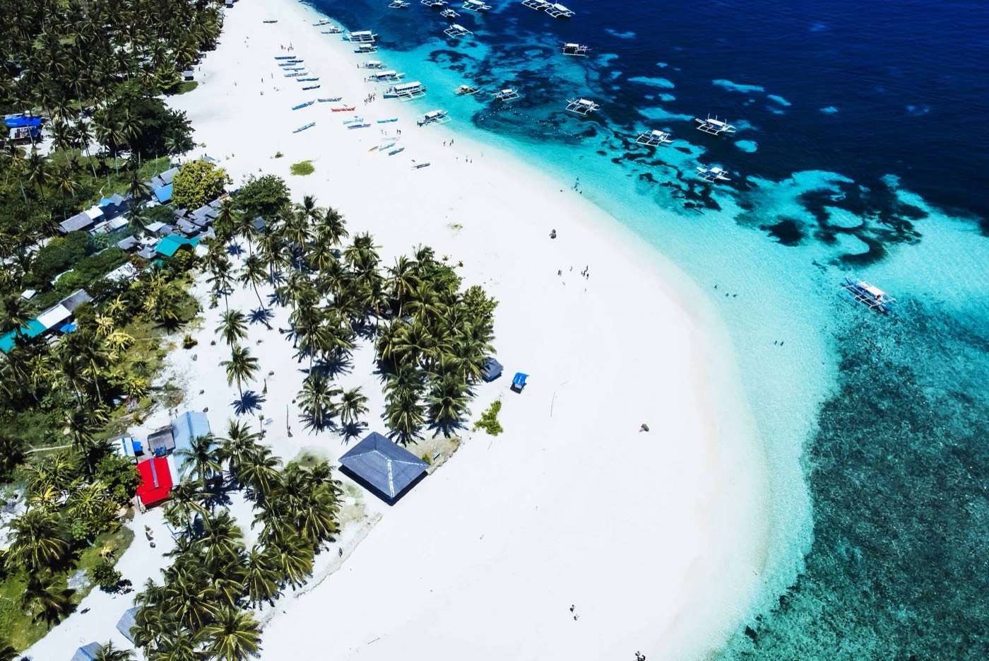 An Aerial View Of A Tropical Island With A White Sand Beach